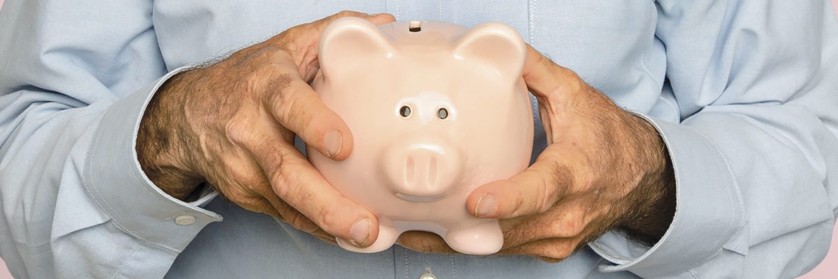 Senior man holding piggy bank for financial savings campaign